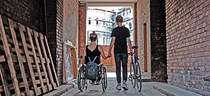 Wheelchair user and cyclist hand in hand. (Photo: Weiland)